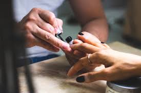 an artist doing nails of the client.